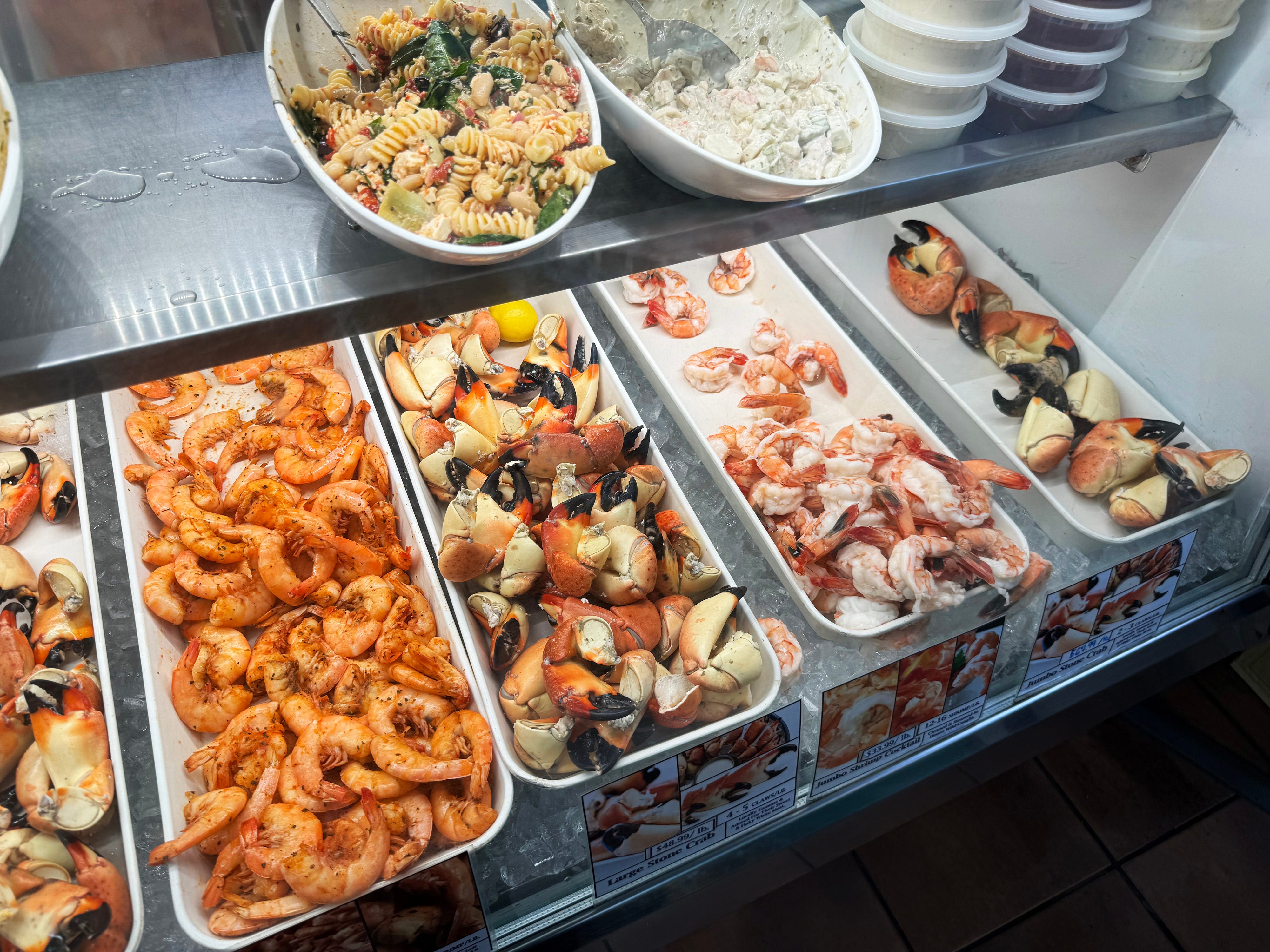 Pasta and shrimp salads (top shelf), stone crab claws and assorted shrimp.
